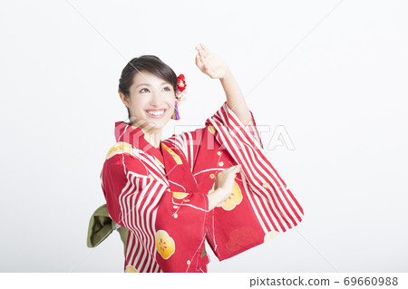 A woman in a yukata dancing a Bon festival dance A woman in a yukata dancing a Bon festival dance 69660988