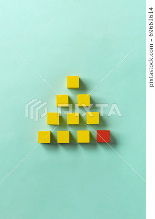 Business material. Pyramid-shaped block. Society, organization, strategy, top-down, foundation, etc. Corner stone. 69661614