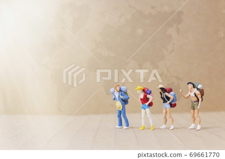 Traveler with backpack walking on The map , Travel and Adventure concepts. Traveler with backpack walking on The map , Travel and Adventure concepts. 69661770