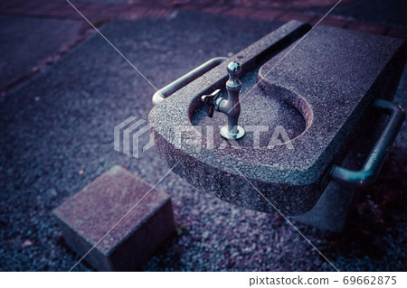 Next to the park drinking fountain 69662875