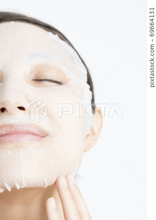 A woman doing a face pack A woman doing a face pack 69664131