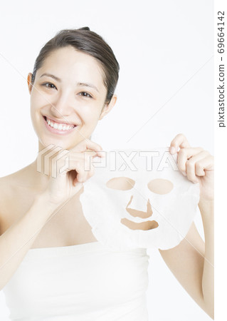 A woman doing a face pack A woman doing a face pack 69664142