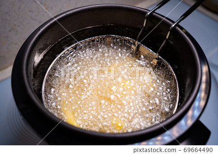 French fries. oil boiling in a deep fryer at home. French fries. oil boiling in a deep fryer at home. 69664490