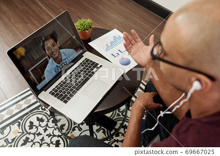 Businessman video calling Vietnamese colleague Businessman video calling Vietnamese colleague 69667025