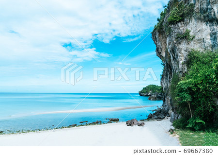 Tropical nature clean beach and white sand in summer with rock mountain blue sky. Tropical nature clean beach and white sand in summer with rock mountain blue sky. 69667380