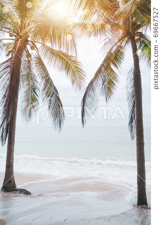 Tropical nature clean beach and white sand in summer with sun light blue sky and bokeh background. Tropical nature clean beach and white sand in summer with sun light blue sky and bokeh background. 69667527