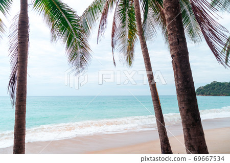 Tropical nature clean beach and white sand in summer with sun light blue sky and bokeh background. Tropical nature clean beach and white sand in summer with sun light blue sky and bokeh background. 69667534