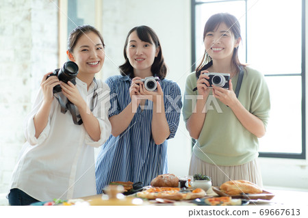 Camera girls attending a camera class 69667613