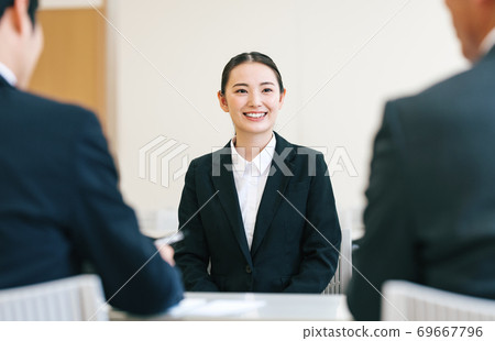 A woman receiving an interview A woman receiving an interview 69667796