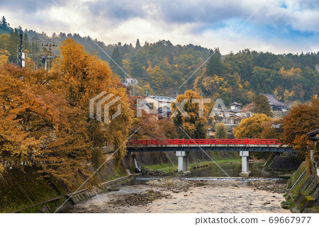 Takayama Japan, autumn landscape foliage at red Nakabashi bridge and Miyakawa river Takayama Japan, autumn landscape foliage at red Nakabashi bridge and Miyakawa river 69667977