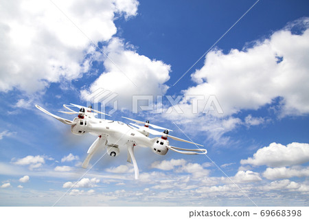 Drone flying in clear sky 69668398
