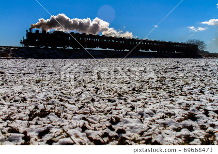 Blue sky and SL silhouette after snowfall Moka Tetsudo 69668471
