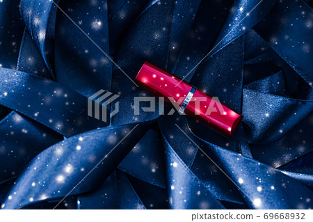 Red lipstick on blue silk and shiny glitter background, luxury make-up and beauty cosmetic Red lipstick on blue silk and shiny glitter background, luxury make-up and beauty cosmetic 69668932