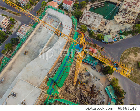 Crane and building under construction. Construction work site 69669148