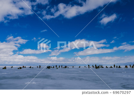 group of fishermen fishing on the ice pond group of fishermen fishing on the ice pond 69670297