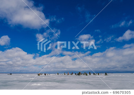 fishermen catch fish in winter on the ice on a day fishermen catch fish in winter on the ice on a day 69670305