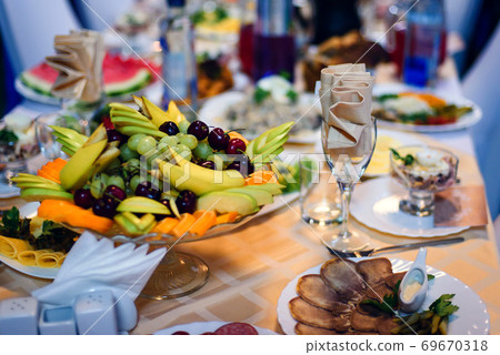 fruit plate with fresh grapes, cherries, orange, banana and Apple 69670318