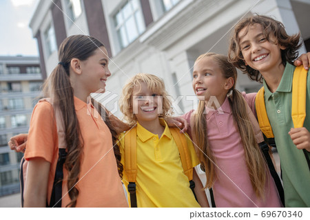 Schoolchildren playing in school yard and looking happy 69670340