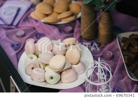 colorful marshmallows and macaroons on a plate colorful marshmallows and macaroons on a plate 69670341