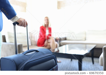 Man hand hold blue suitcase by handle. Man hand hold blue suitcase by handle. 69670350
