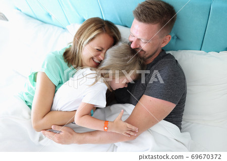 Happy family spend time together at home in bed. Happy family spend time together at home in bed. 69670372