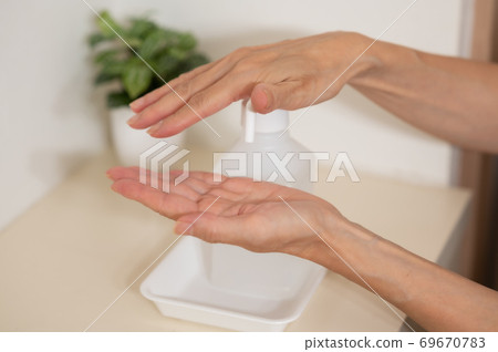 Corona measures Hand disinfection and sterilization at the entrance 69670783
