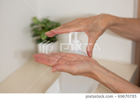 Corona measures Hand disinfection and sterilization at the entrance 69670785