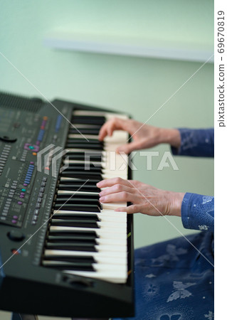 female hands black white piano keys synth close-up female hands black white piano keys synth close-up 69670819