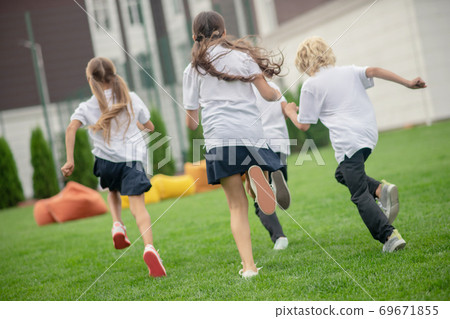 Group of teens having a running competition 69671855