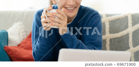 Young man making a video call [Living] 69671900