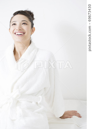 A woman in a bathrobe A woman in a bathrobe 69673430