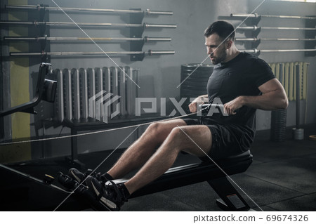 Sportsman Has Arms Workout On Rowing Machine . 69674326
