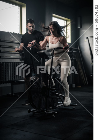 Slim Woman Do Exercises On Stationary Bike . Slim Woman Do Exercises On Stationary Bike . 69674382