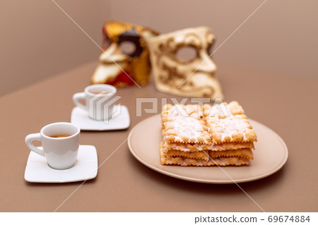 Typical Italian carnival fritters (Chiacchiere di Carnevale) dusted with powdered. Typical Italian carnival fritters (Chiacchiere di Carnevale) dusted with powdered. 69674884