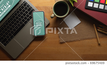 Worktable with mock up smartphone, laptop, coffee and paint tools Worktable with mock up smartphone, laptop, coffee and paint tools 69675489