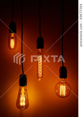 Set of a vintage light bulb on orange background. Glowing edison bulb Set of a vintage light bulb on orange background. Glowing edison bulb 69675564