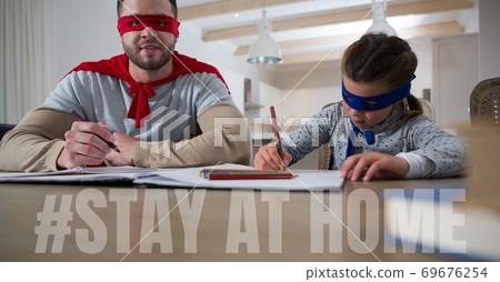 Caucasian man and girl wearing capes with words Stay Home during coronavirus covid19 pandemic Caucasian man and girl wearing capes with words Stay Home during coronavirus covid19 pandemic 69676254