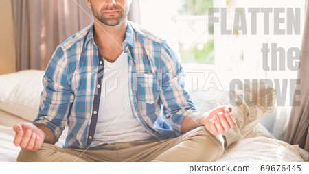 Caucasian man meditating with words Flatten the Curve during coronavirus covid19 pandemic 69676445