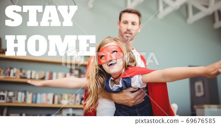 Caucasian man and girl wearing capes with words Stay Home during coronavirus covid19 pandemic 69676585