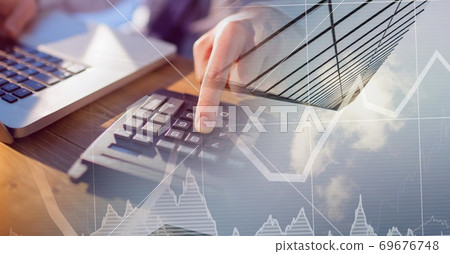 Caucasian male hands calculating over statistics and a blue sky Caucasian male hands calculating over statistics and a blue sky 69676748