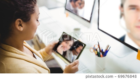 Woman having video call on digital tablet 69676848