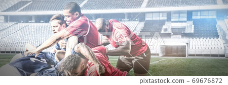 Digital composite image of team of rugby players playing rugby in sports stadium Digital composite image of team of rugby players playing rugby in sports stadium 69676872