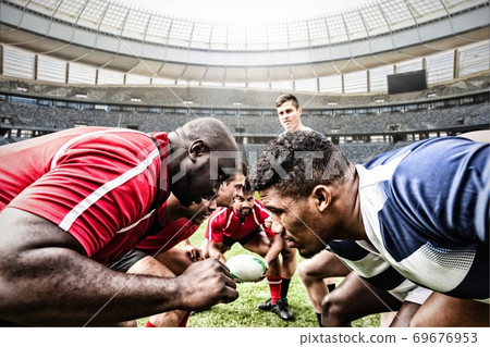 Digital composite image of team of rugby players facing each other in sports stadium Digital composite image of team of rugby players facing each other in sports stadium 69676953