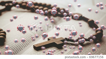 Covid-19 cells against rosary on bible 69677156