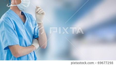 Mid section of female doctor in hospital wearing coronavirus covid19 mask 69677298