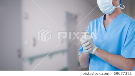Mid section of male doctor in hospital wearing coronavirus covid19 mask 69677351