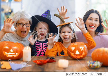 family celebrating Halloween family celebrating Halloween 69678833