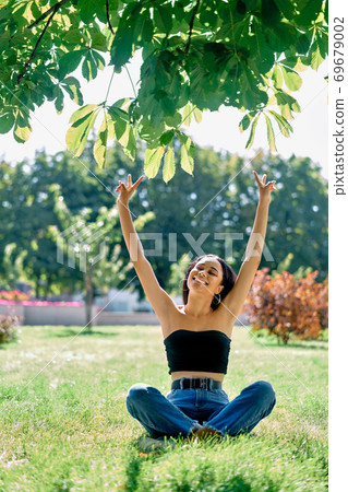 Freedom happy afro american woman with arms up relax in park 69679002
