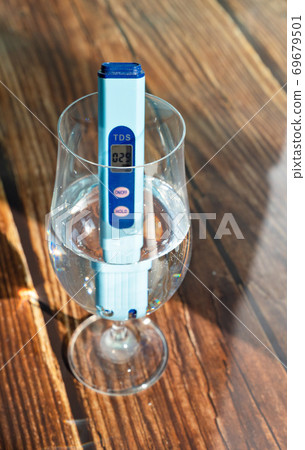 TDS meter in glass to determine quality  water. 69679501