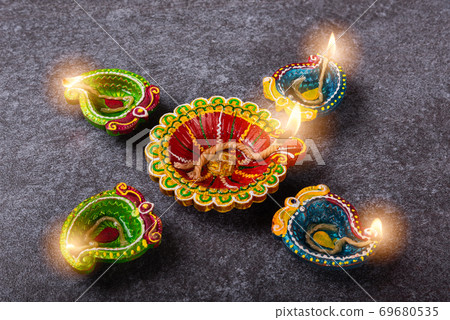 clay lit light a fire already on Diya or oil lamp clay lit light a fire already on Diya or oil lamp 69680535